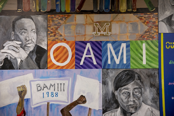 Image of wall mural in OAMI that features MLK, Cesar Chavez, and the Black Action Movement