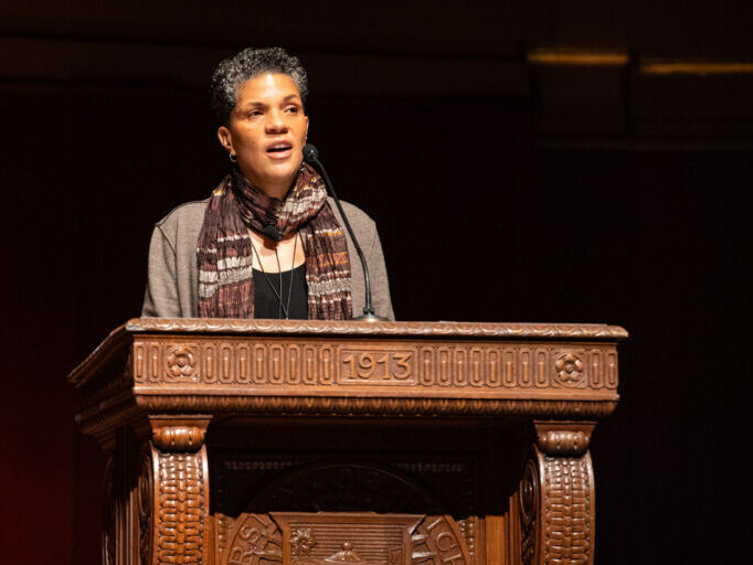 woman standing behind a podium speaking