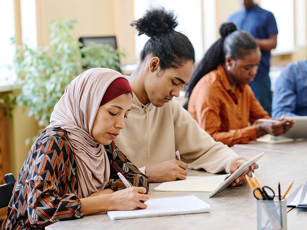 Group of diverse students studying at a table