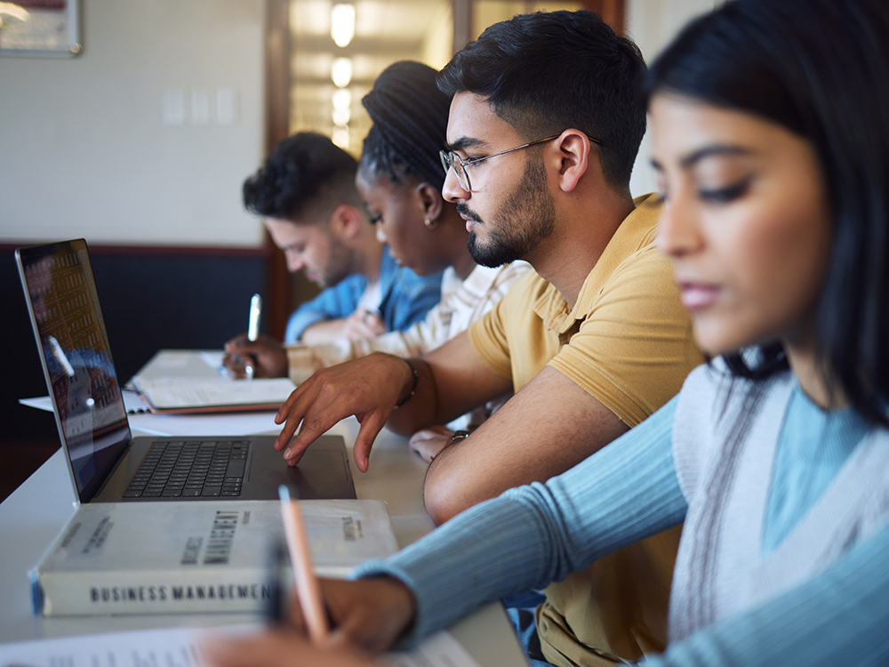 Photo of students working on laptops