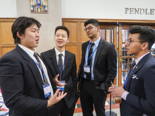 Photo of students talking at a conference