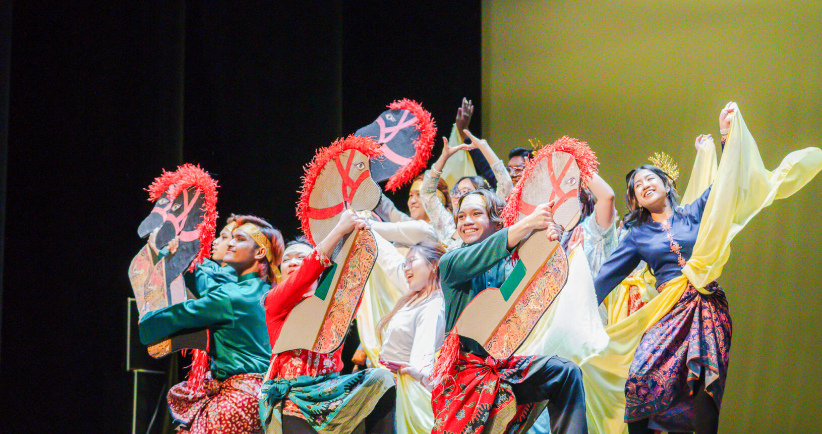 Photo of students performing in traditional regalia