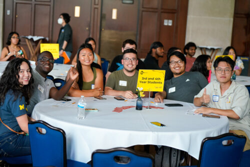 3rd and 4th year students at a table