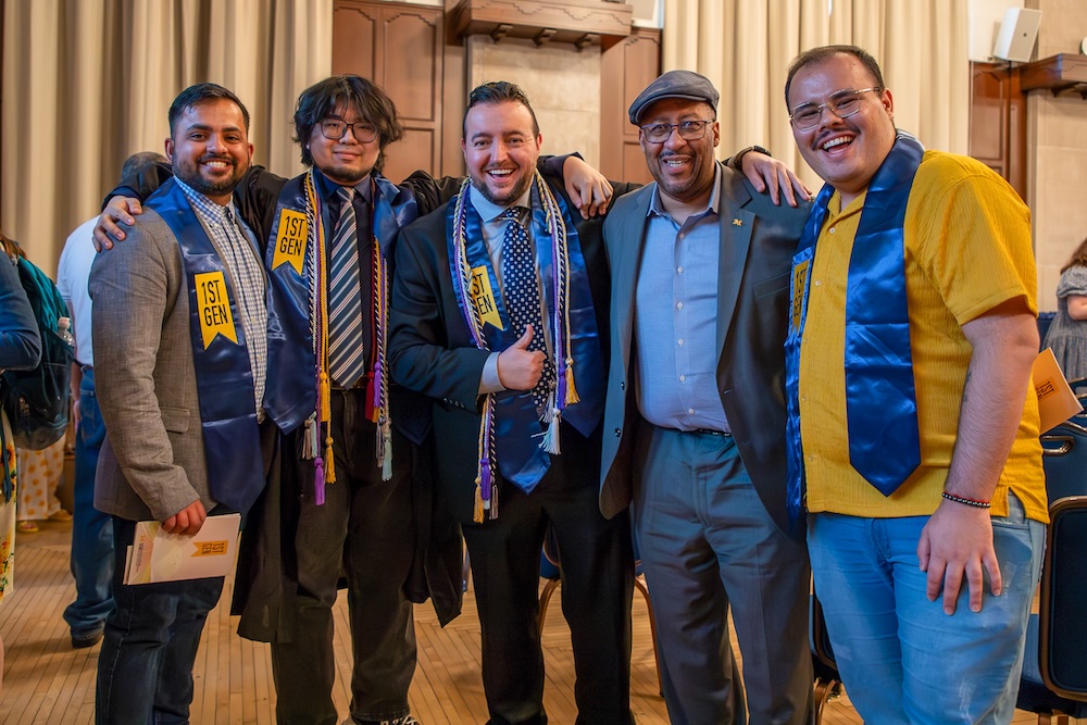 A group of students wearing First-Gen stoles smile at the celebration